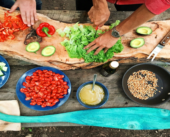 hands working working over a counter cutting produce
